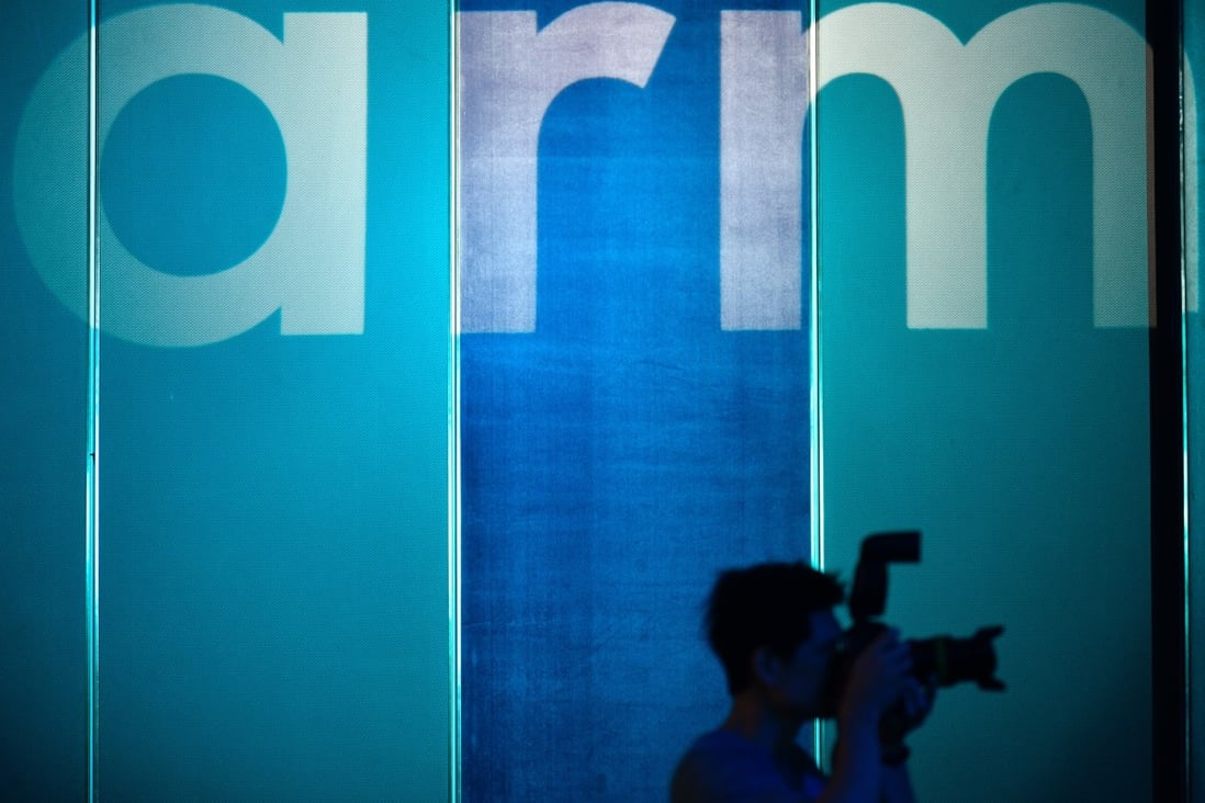 A photographer is seen in front of the logo of British chip design company Arm in Taipei on May 27, 2019. Photo: Agence France-Presse