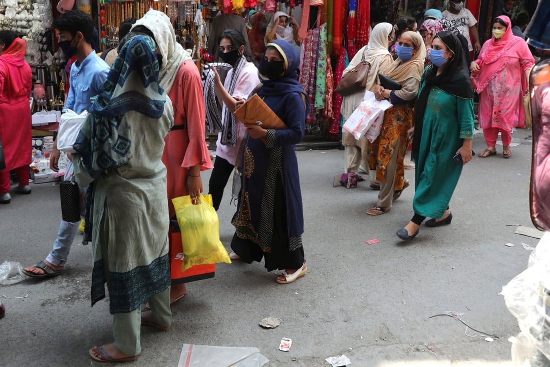 Women are seen shopping in Srinagar, the summer capital of Indian Kashmir, as coronavirus restrictions were eased ahead of the Eid-ul-Adha religious festival. Women have borne the brunt of the ongoing conflict in Kashmir. Photo: EPA