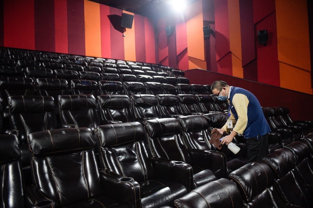 Cinemas have begun reopening in China, but with mask-wearing and social-distancing restrictions that are a reminder that movie-going is anything but back to normal. Here, a worker disinfects seats at a Beijing cinema on July 21, 2020. Photo: Xinhua