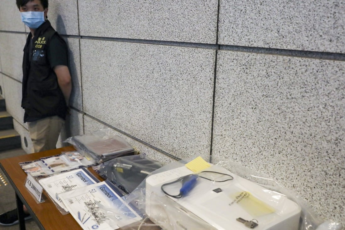 Police display fake HK$500 notes, a colour printer, and other items allegedly seized in a raid on a suspected counterfeiter’s operation on Tuesday. Photo: K. Y. Cheng