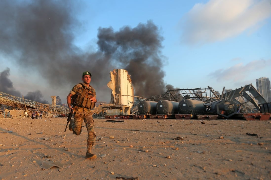 A Lebanese army soldier runs at the scene of the explosion at the port of Lebanon's capital Beirut. Photo: AFP