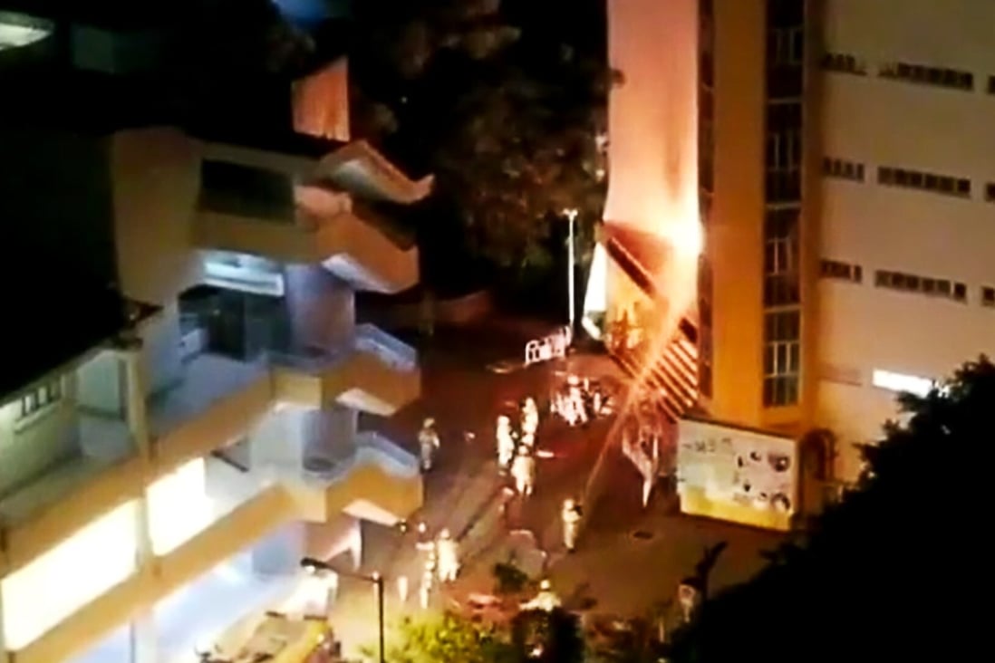Firefighters tackle the blaze from a firebomb attack at the entrance of Lok Sin Tong Leung Chik Wai Memorial School in Tsing Yi in July. Photo: Facebook