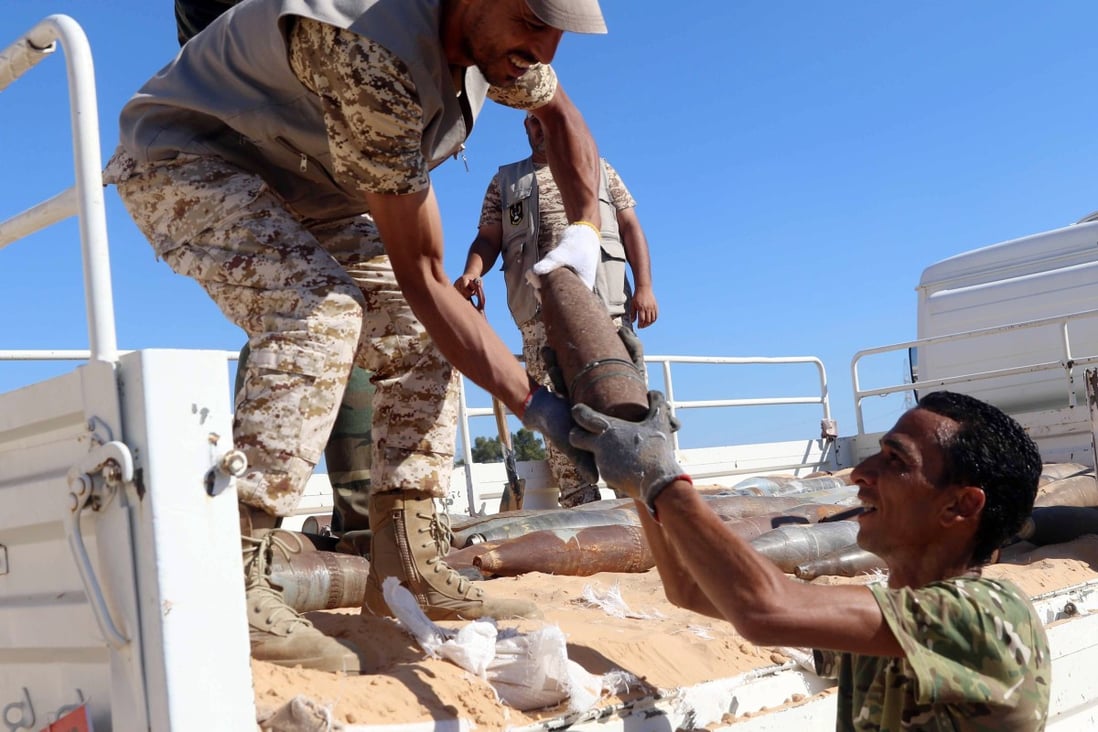 Military engineers of the UN-recognised Libyan Government of National Accord (GNA) collect mines and explosive devices uncovered from areas Al-Takbali camp. Photo: EPA-EFE