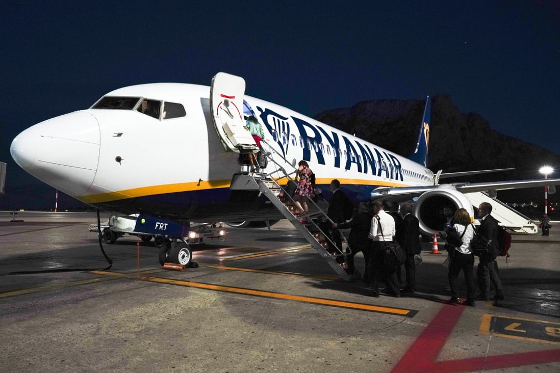 Passengers board a Ryanair aeroplane, in Palermo, Italy. Photo: AP Photo