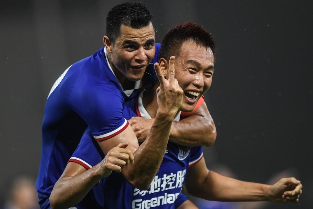 Kim Shin-wook of Shanghai Shenhua celebrates his goal with captain Giovanni Moreno. Photo: Xinhua