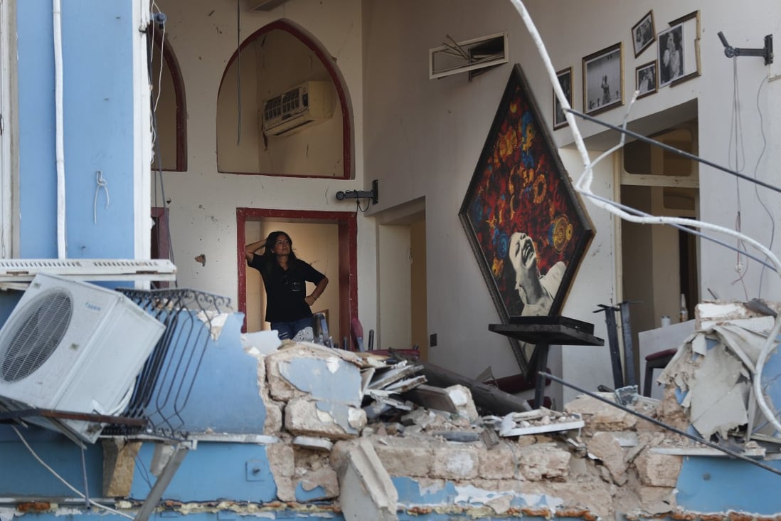 A woman stands inside a damaged restaurant a day after an explosion ripped through the seaport of Beirut, Lebanon. Photo: AP