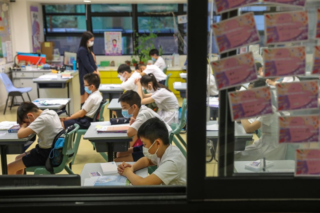 Students and teachers at S.K.H. St. James’ Primary School in Wan Chai pray for an easing of the coronavirus situation in Hong Kong as classes resumed in late June. A return to online learning was only about a month away. Photo: Nora Tam
