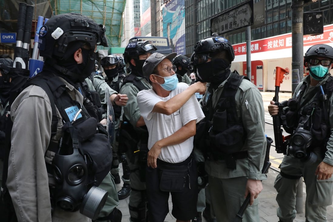 A spectator argues with riot police after being told to step further away during an anti-government demonstration in the financial district of Central on May 27. Photo: Nora Tam