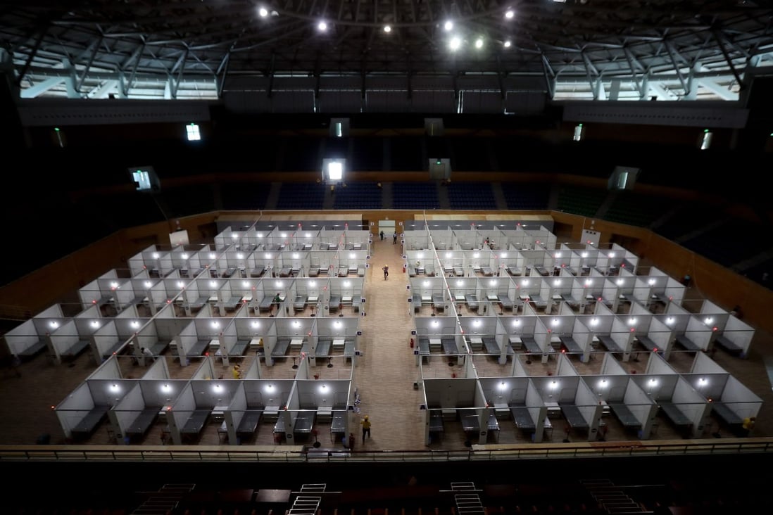 Workers prepare a makeshift field hospital inside the Tien Son sports complex in Da Nang, the new epicentre of Vietnam’s outbreak. Photo: AFP