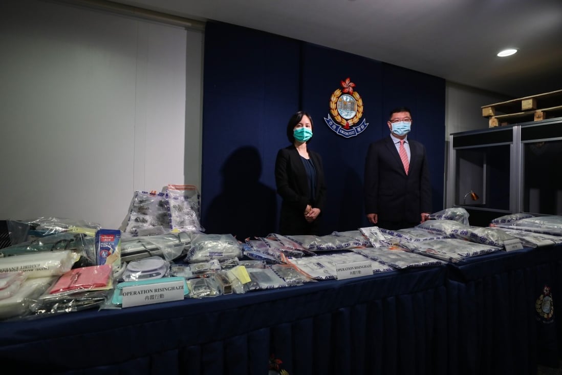 Chief Inspector Ip Siu-lan (left) and Senior Superintendent Ng Kwok-cheung (right) of the Narcotics Bureau stand behind a haul of recently seized drugs at a press conference on Friday. Photo: Xiaomei Chen