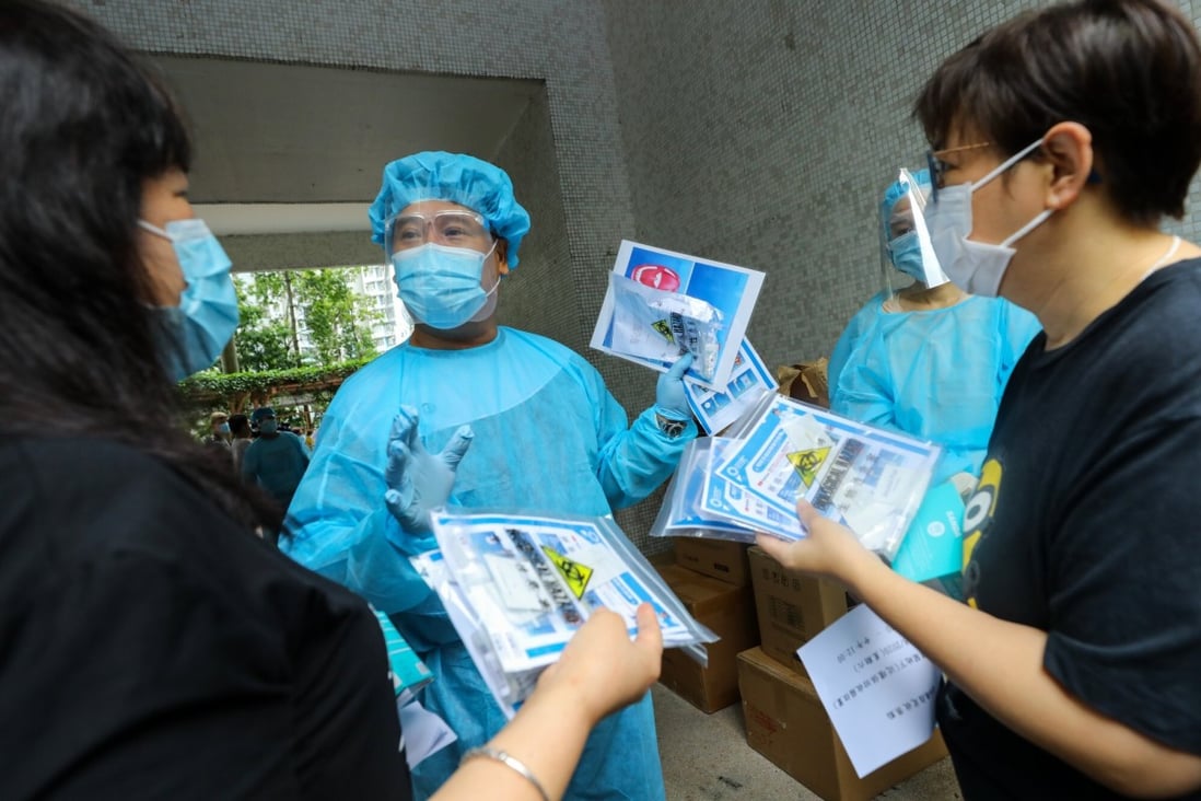 Medical staff give out testing kits to residents in Ping Shek Estate in Kwun Tong. Photo: Dickson Lee