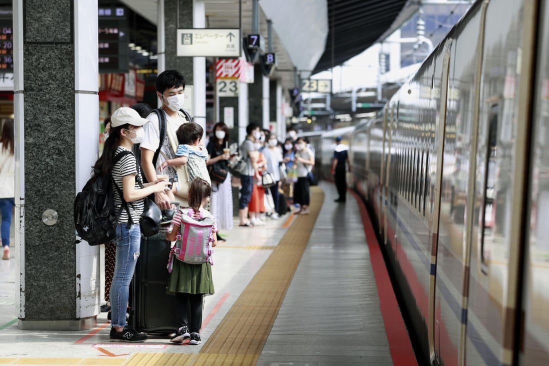 Passengers wait to get on a shinkansen bullet train at JR Tokyo Station on Saturday, as fewer people head to their hometowns over the summer holiday period. Photo: Kyodo