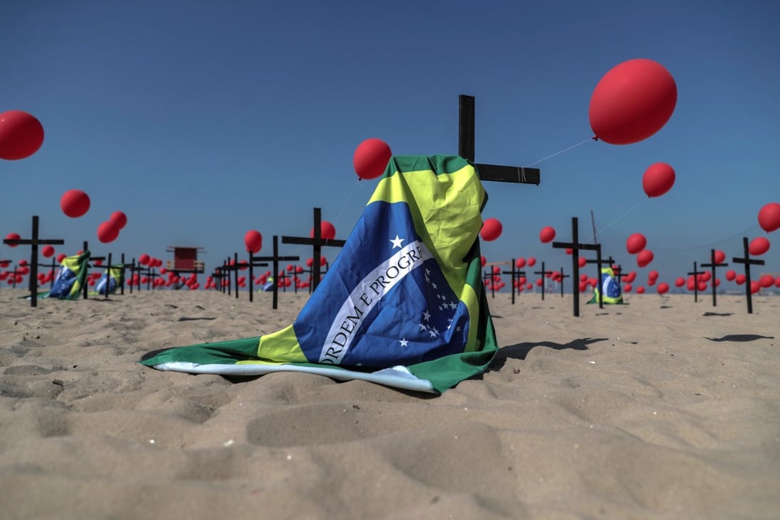 An installation of red balloons and crosses honouring victims of the coronavirus pandemic in Brazil was set up at Copacabana beach in Rio de Janeiro, Brazil on Saturday. Photo: EPA-EFE