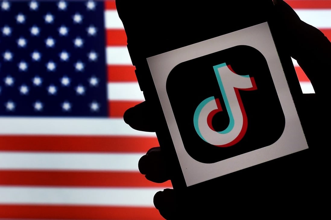 In this file illustration photo taken on August 3, 2020 the social media application logo TikTok is displayed on the screen of an iPhone on an American flag background. Photo: AFP