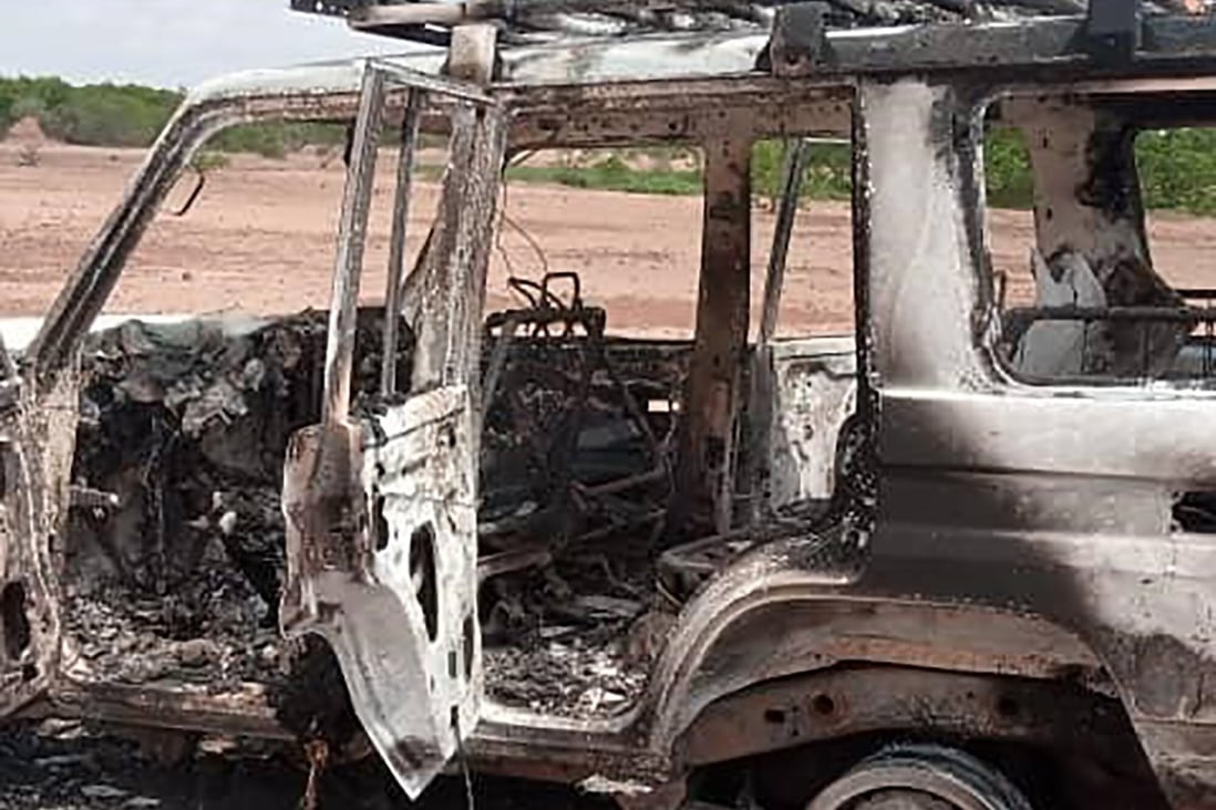 The burnt-out remains of a 4x4 vehicle with bullet holes in the side. Photo: AFP