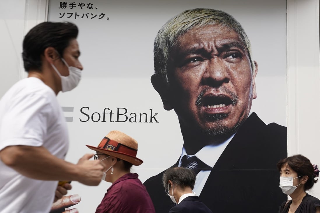 Pedestrians wearing protective masks walk past a SoftBank store in Tokyo, Japan, on August 7. Photo: Bloomberg