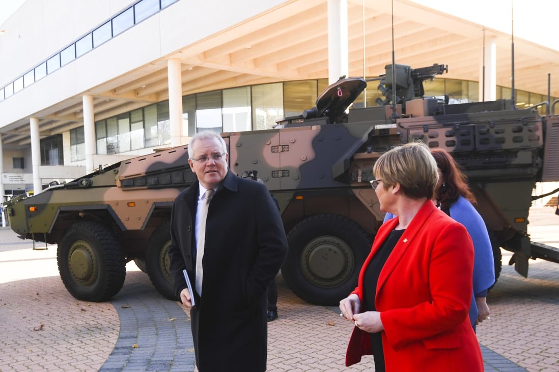 Australian Prime Minister Scott Morrison and Defence Minister Linda Reynolds walk past an armoured combat vehicle as they arrive at the Australian Defence Force Academy in Canberra on July 1. Morrison has pledged to spend billions on defence over the next 10 years in a move widely seen as aimed at countering China’s growing presence in the region. Photo: EPA