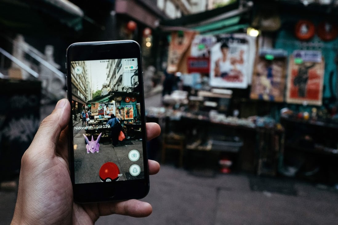 A smartphone showing Pokémon Go is seen in front of a stall on July 25, 2016, in Hong Kong, where the game is not banned. Photo: Bloomberg