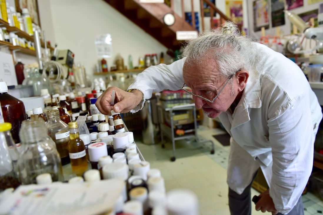 Geneticist and “aroma sculptor” Michael Moisseeff examines items in his laboratory in Montegut-Lauragais near Toulouse, southwestern France, in July. Photo: AFP