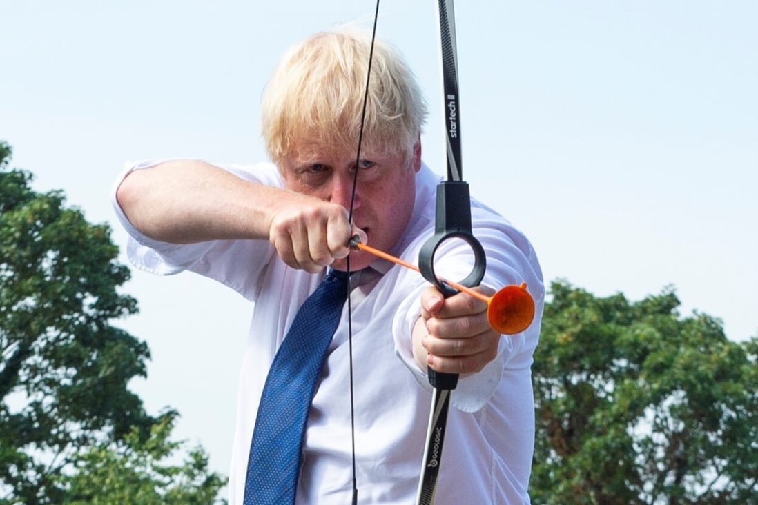 Britain's Prime Minister Boris Johnson tries some archery during a visit to a school in London. Photo: Reuters