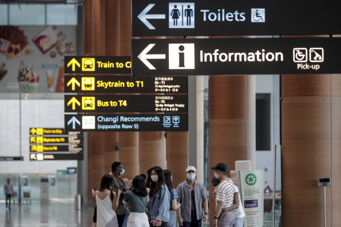 A group of travellers pictured in the departure hall of Changi Airport in Singapore on July 30. Photo: EPA