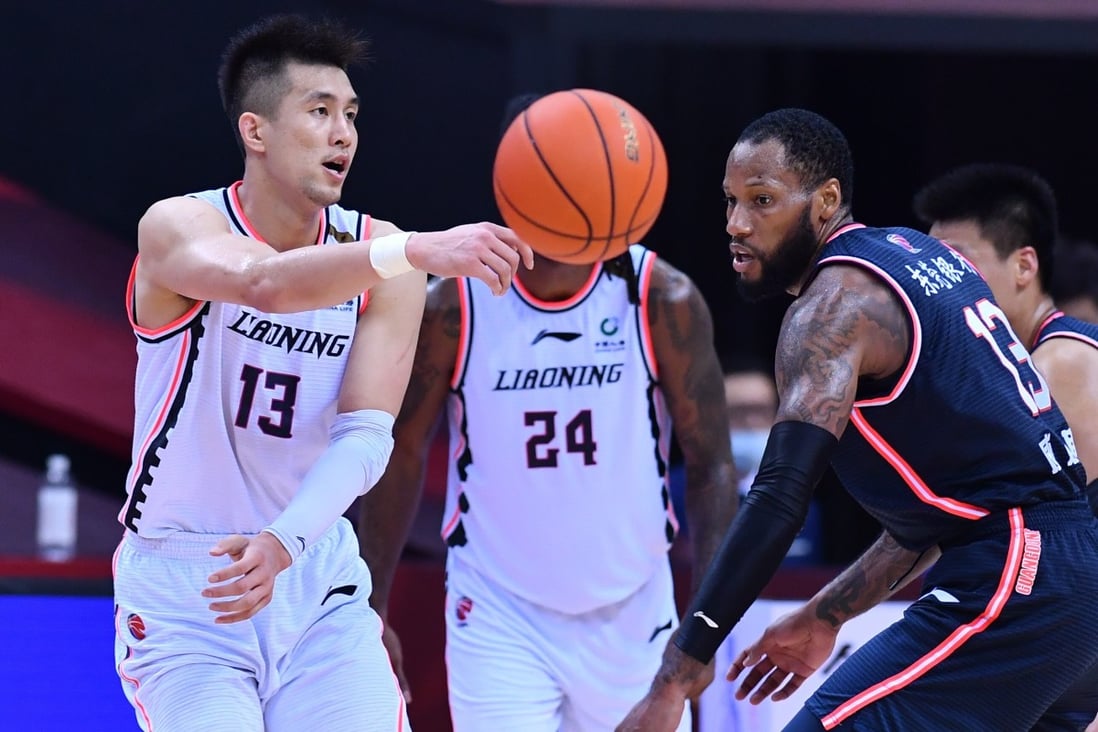 Guo Ailun (left) of Liaoning Flying Leopards passes the ball during the second game of the finals between Guangdong Southern Tigers and Liaoning Flying Leopards. Photo: Xinhua