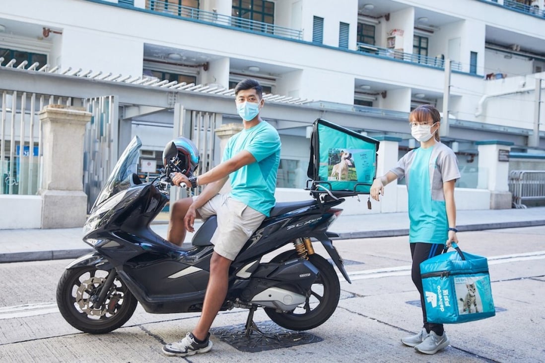 Deliveroo employees display photos of animals that are up for adoption. Photo: Deliveroo / Hong Kong Saving Cats and Dogs Association