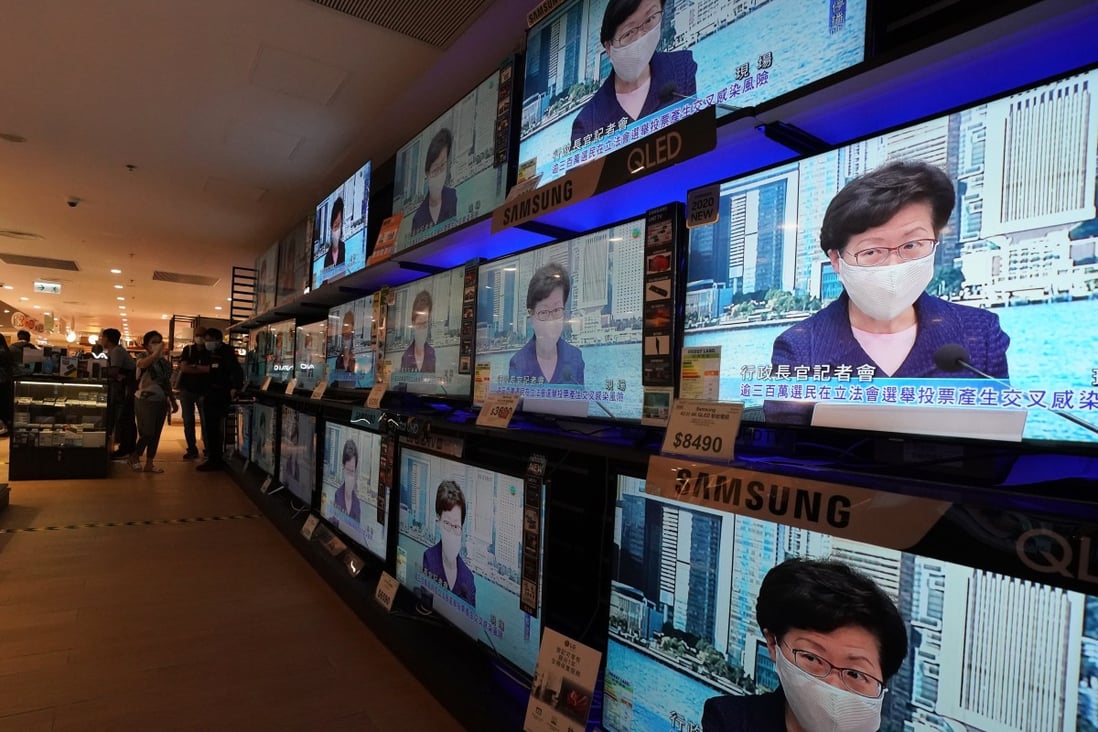 Screens at an electronic store in Taikoo Shing broadcast a press conference by Hong Kong Chief Executive Carrie Lam Cheng Yuet-ngor on July 31, announcing the postponement of the September 6 Legislative Council election for a year over a fresh Covid-19 wave in the city. Photo: Felix Wong