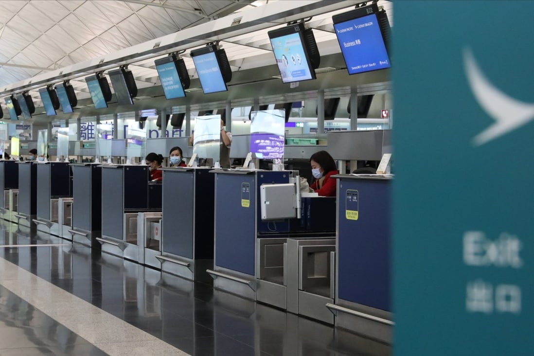 Cathay Pacific staff wait at the check in desks at Hong Kong International Airport. Photo: Nora Tam