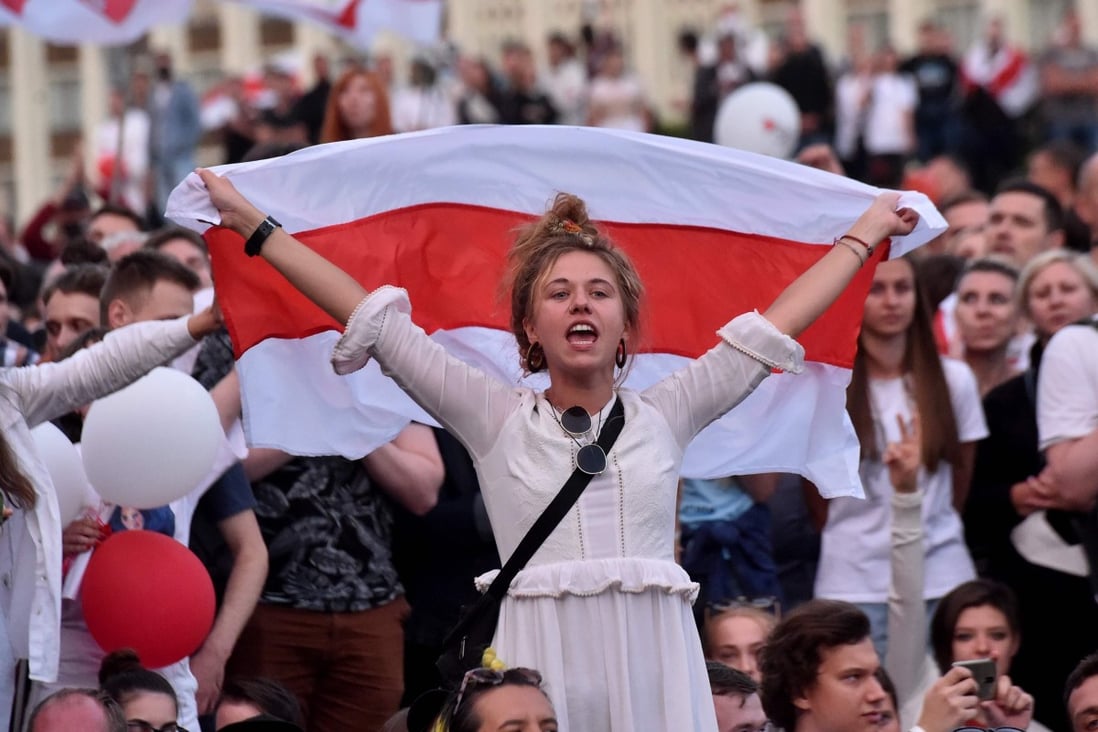 A woman holds a Belarus flag during a protest rally against police violence in central Minsk on August 14, 2020. Photo: AFP