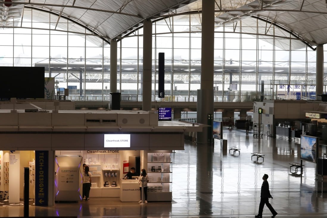 A man walks through a deserted Hong Kong International Airport as staff disinfect one of the shops on the main concourse. Photo: Nora Tam