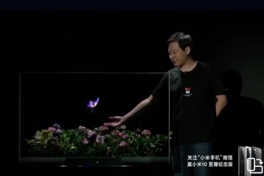 Xiaomi Corp founder and chief executive Lei Jun shows the company's new Mi TV LUX Transparent Edition in Beijing on August 11. Photo: Handout