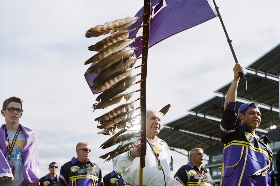 Faithkeeper Oren Lyons and Iroquois Nations Team march on to field during an international tournament. Photo: One Bowl Productions