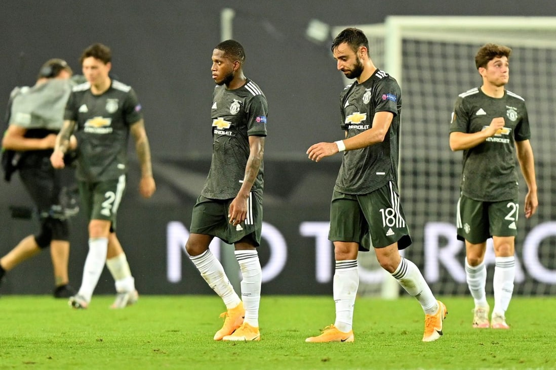 Dejected Manchester players leave the pitch after their Europa League loss to Sevilla. Photo: Reuters