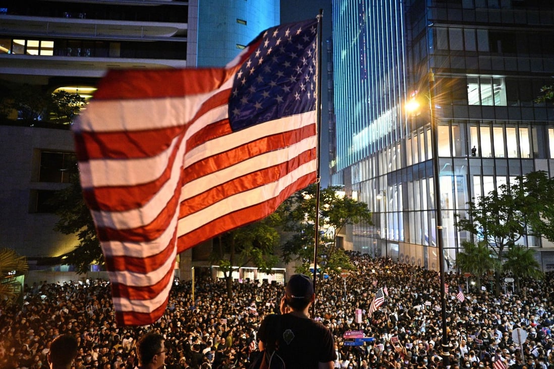 A man waves a US national flag at an anti-government rally in Hong Kong in 2019. Photo: AFP