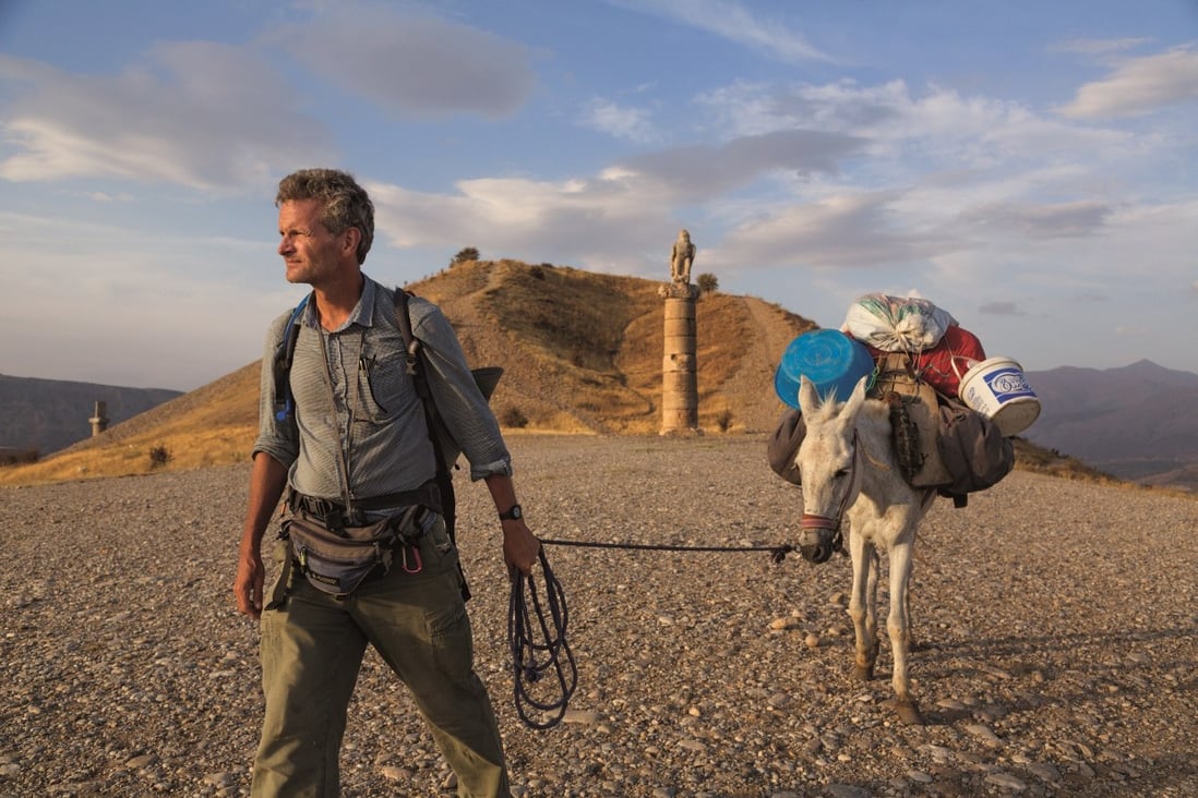 Journalist and National Geographic fellow Paul Salopek walks past the Karakus royal tomb, built in the first century BC, in eastern Turkey on his 21,000-mile trek around the world following in the footsteps of early humans. Photo: John Stanmeyer / National Geographic