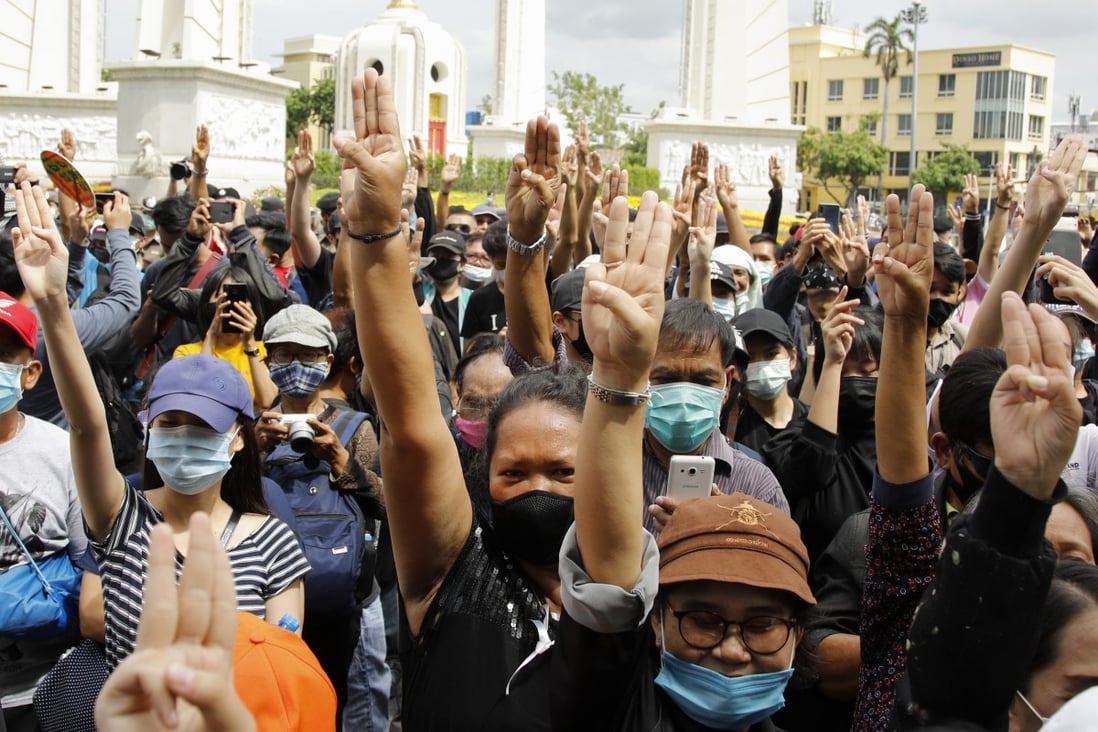 Thai protesters flash the three-finger salute during an anti-government protest at the Democracy Monument in Bangkok. Photo: EPA