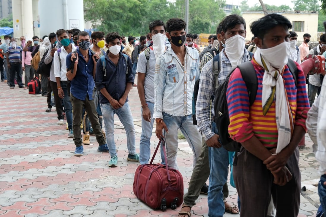 Migrant workers arriving from neighbouring states queue for Covid-19 testing in New Delhi. Photo: Bloomberg