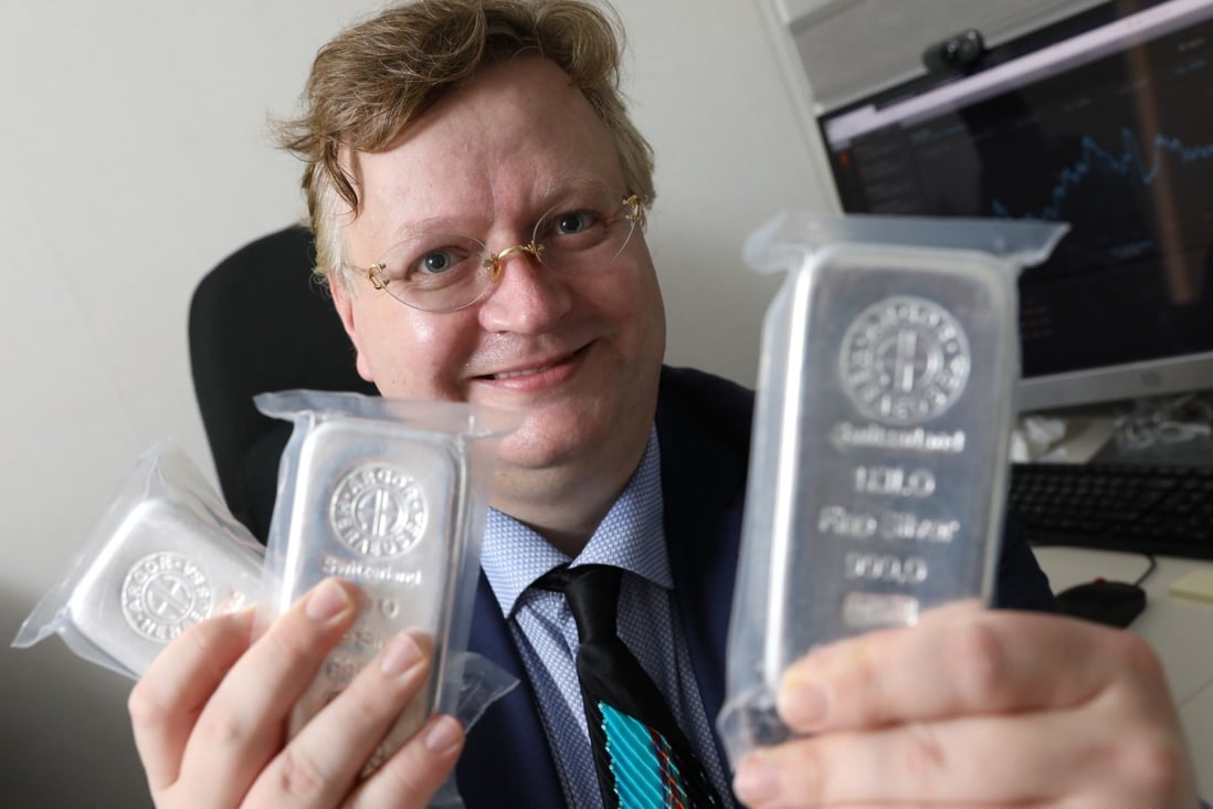 Pádraig Seif, partner of Precious Metal Asia, holds silver bars in his office in Sheung Wan. He reports a surge in buying interest in silver. Photo: May Tse