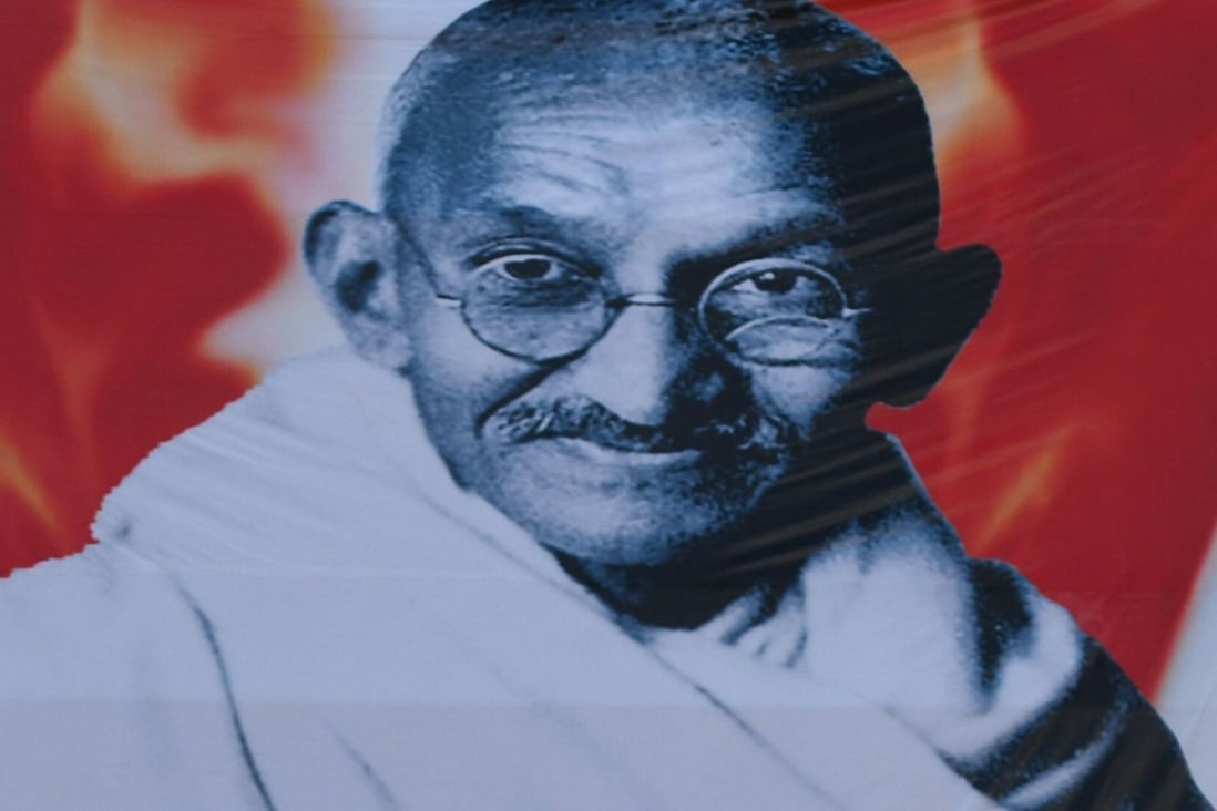 A poster of Mahatma Gandhi. A pair of his glasses sold in an auction in the UK. Photo: AFP
