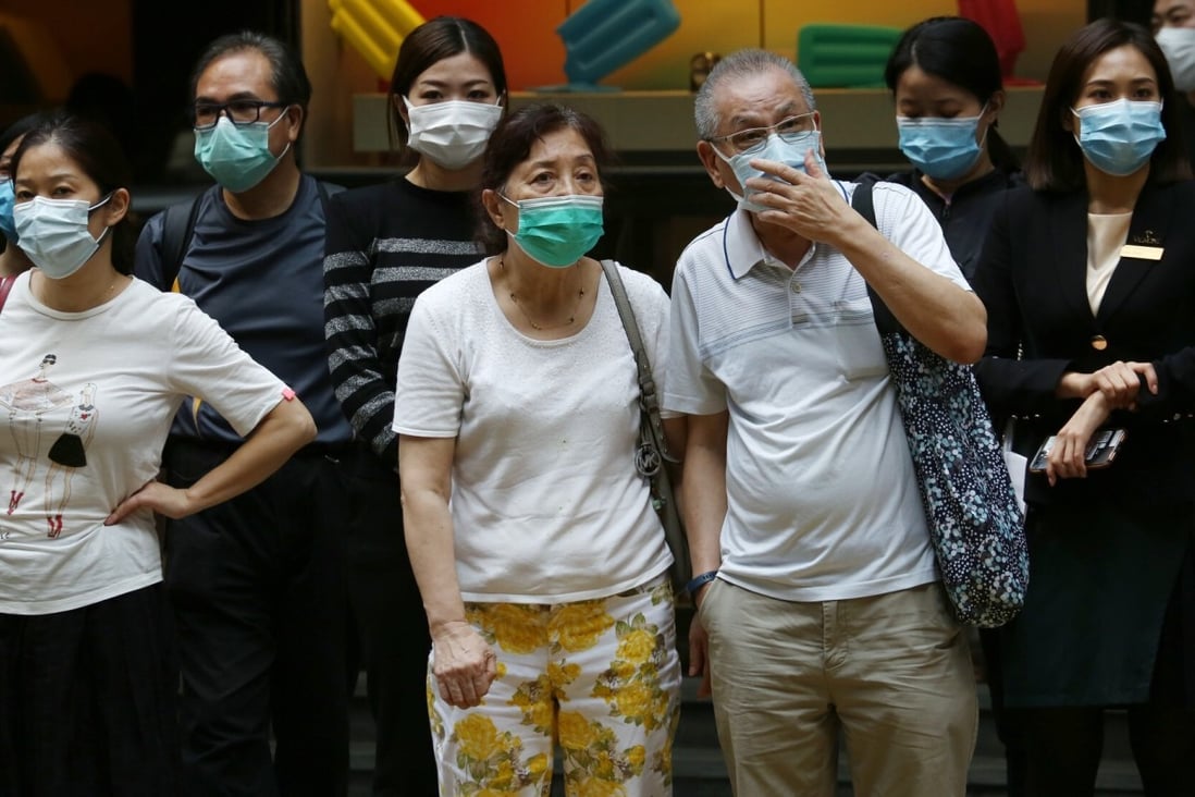 Pedestrians in masks waiting to cross the road in Central, Hong Kong. Photo: Jonathan Wong