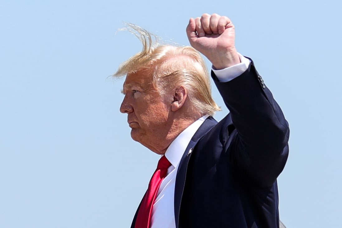 US President Donald Trump raises his fist as he arrives at Bangor International Airport in Maine, US, on June 5. Photo: Reuters