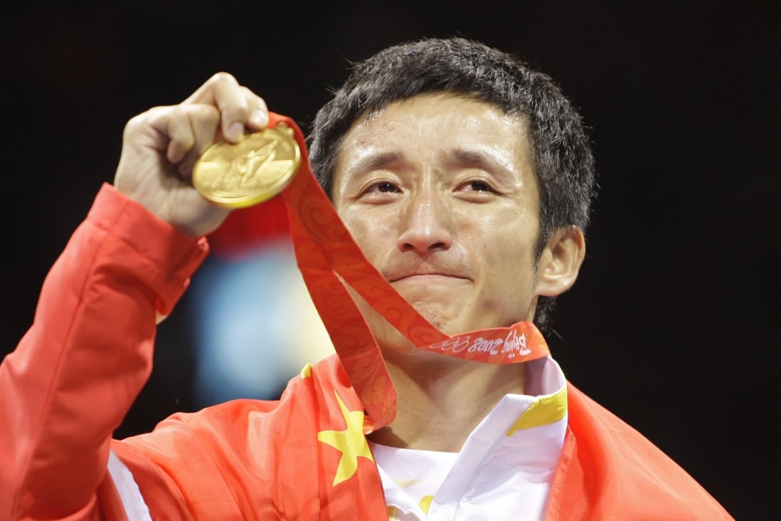 Zou Shiming of China displays his gold medal after defeating Serdamba Purevdorj of Mongolia during the men’s light flyweight final at the Beijing 2008 Olympics. Photo: AP