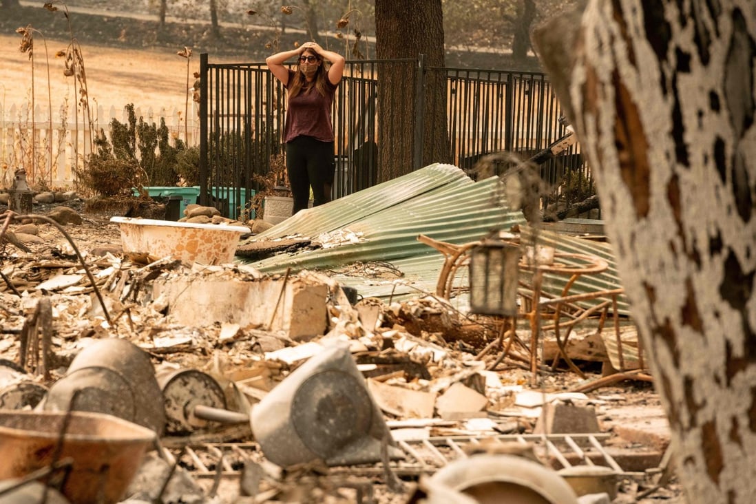 Alyssa Medina examines the charred remains of her family home in Vacaville, California. Photo: AFP