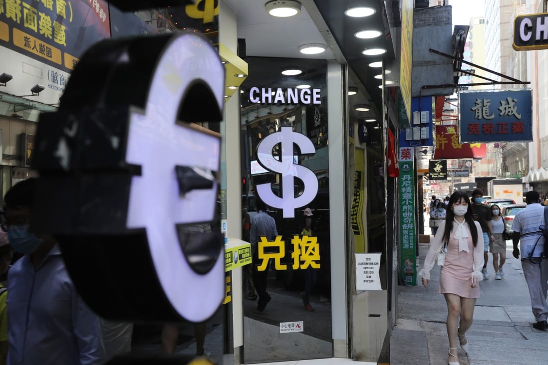 Symbols for the euro and US dollar at currency exchange booths in Tsim Sha Tsui, Hong Kong. Photo: Sam Tsang