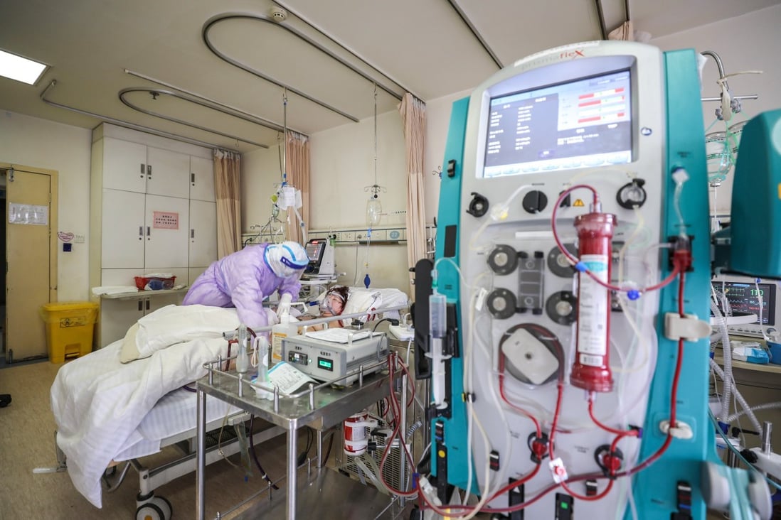 A Covid-19 patient is treated at the Red Cross Hospital in Wuhan in February. Experts say the public health systems of many countries have been overwhelmed and they have little capacity to deal with TB. Photo: AFP