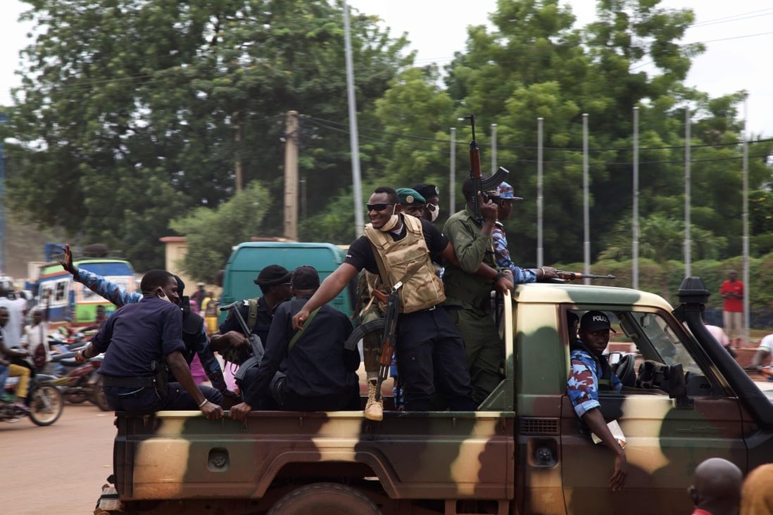 Malian soldiers drive through the streets of Bamako on Wednesday, a day after rebel military leaders forced President Ibrahim Boubacar Keita from office. Photo: AFP