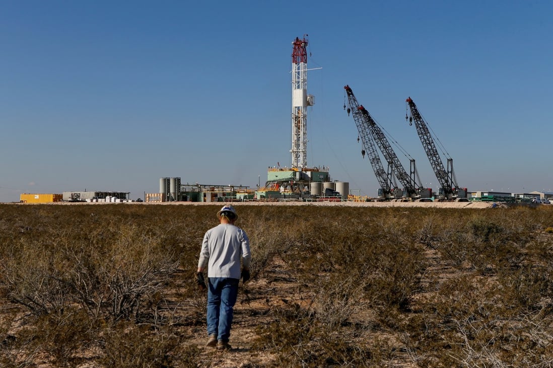 An oil worker near a drill rig in Loving County, Texas. Photo: Reuters