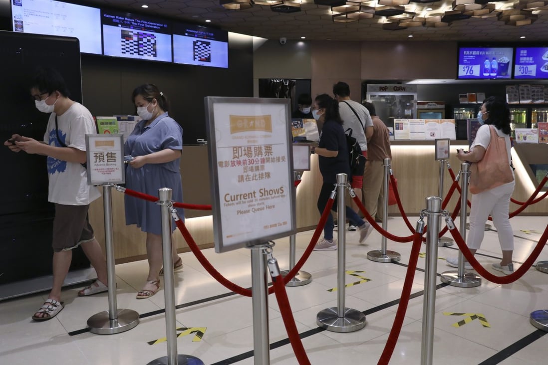 Cinemas can reopen on Friday but must operate at half capacity. Pictured, people buying tickets in May before social-distancing measures forced cinemas to close. Photo: Nora Tam
