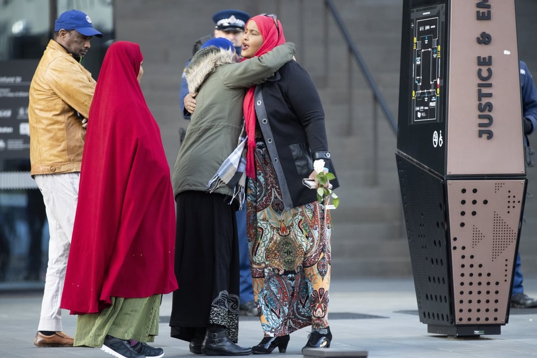 Victims and relatives embrace as they wait to enter the Christchurch High Court for the final day in the sentencing hearing for Brenton Tarrant on Thursday. Photo: AP